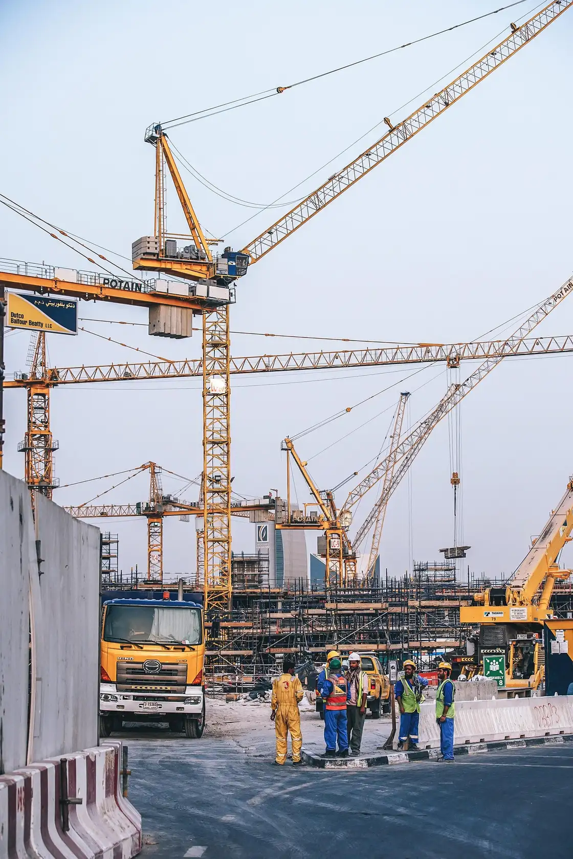 Tower cranes rising over a large construction site